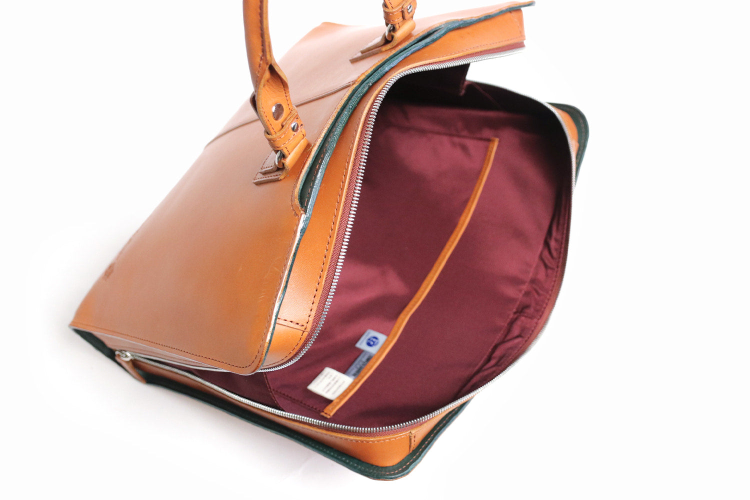 COMPLEX GARDENS / 眼蔵 ゲンゾウ 上質で肉厚なバケッタレザーを贅沢に使用したラウンドジップB4ブリーフケース