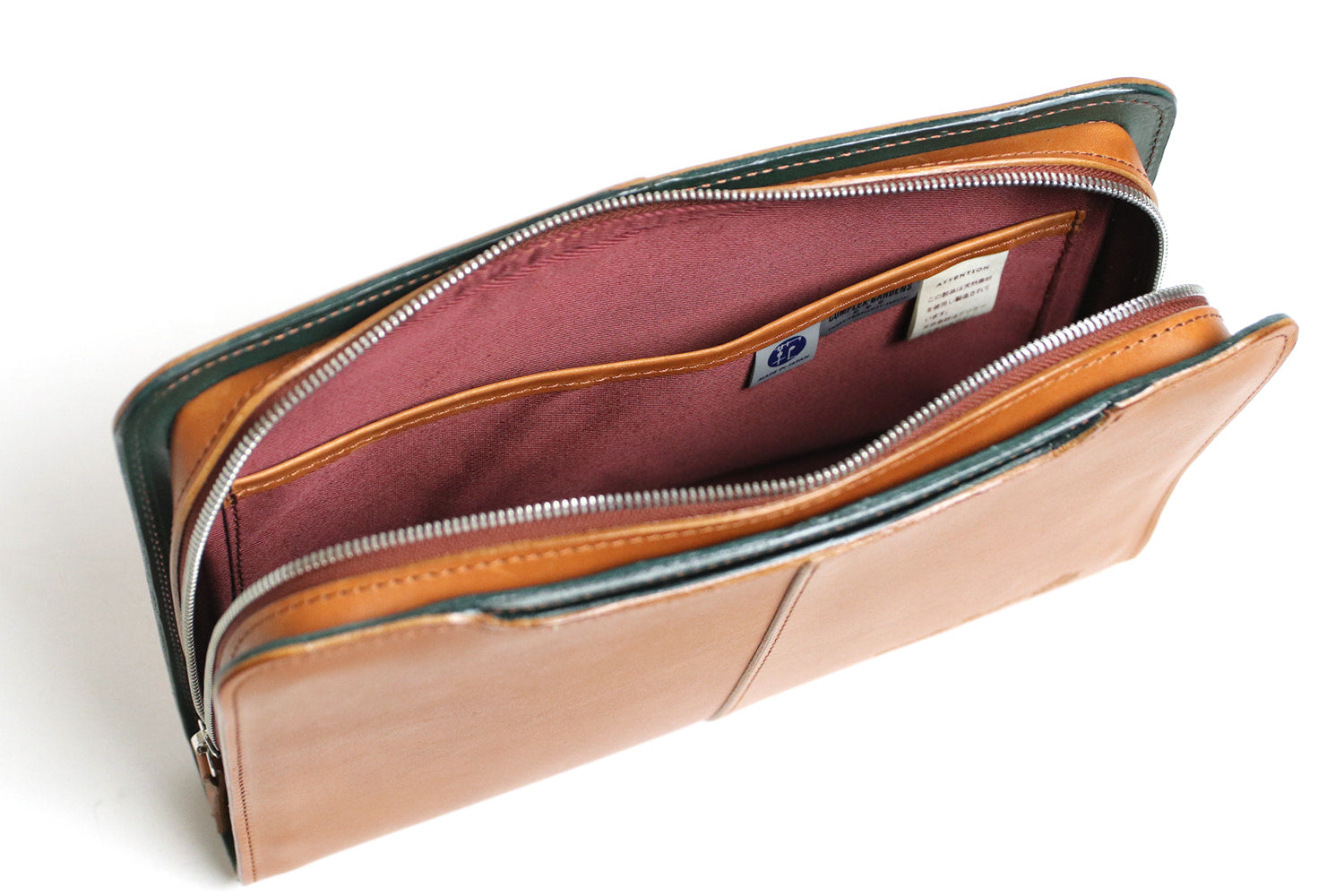 COMPLEX GARDENS / 眼蔵 ゲンゾウ  上質で肉厚なバケッタレザーを贅沢に使用したラウンドジップクラッチバッグ