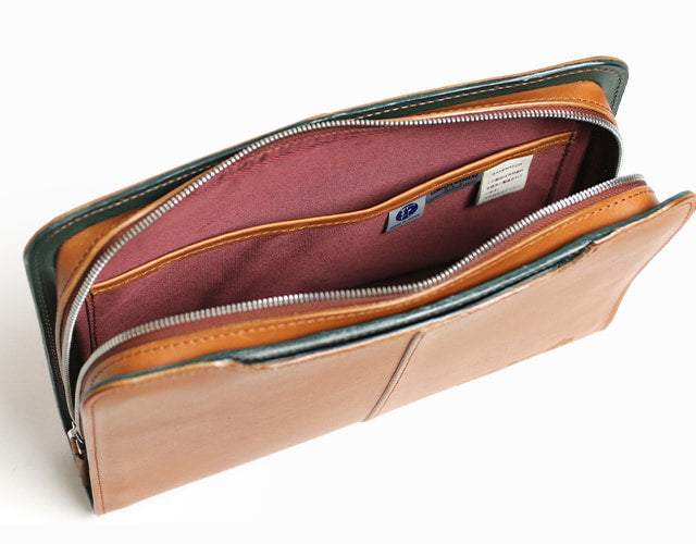 COMPLEX GARDENS / 眼蔵 ゲンゾウ  上質で肉厚なバケッタレザーを贅沢に使用したラウンドジップクラッチバッグ