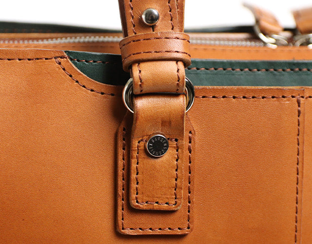 COMPLEX GARDENS / 眼蔵 ゲンゾウ  上質で肉厚なバケッタレザーを贅沢に使用したラウンドジップB4ブリーフケース