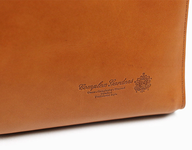 COMPLEX GARDENS / 眼蔵 ゲンゾウ  上質で肉厚なバケッタレザーを贅沢に使用したラウンドジップB4ブリーフケース